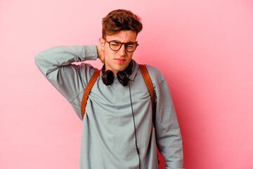 Fototapeta premium Young student man isolated on pink background suffering neck pain due to sedentary lifestyle.