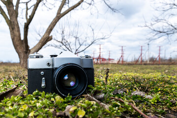 forgotten old film camera lies in the garden