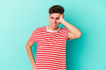 Young caucasian man isolated on blue background celebrating a victory, passion and enthusiasm, happy expression.