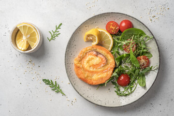 Salmon Pinwheel stuffed with cheese with salad
