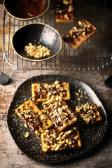 Selective focus. French waffles with chocolate and nuts. Making waffles
