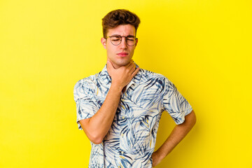 Young caucasian man isolated on yellow background suffers pain in throat due a virus or infection.
