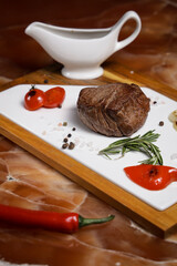Large steak with sauce on the board