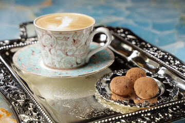 cappuccino with chocolate candy on a tray