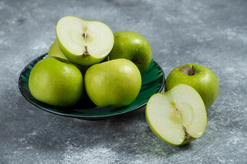 Three fresh whole and sliced apples on wooden piece