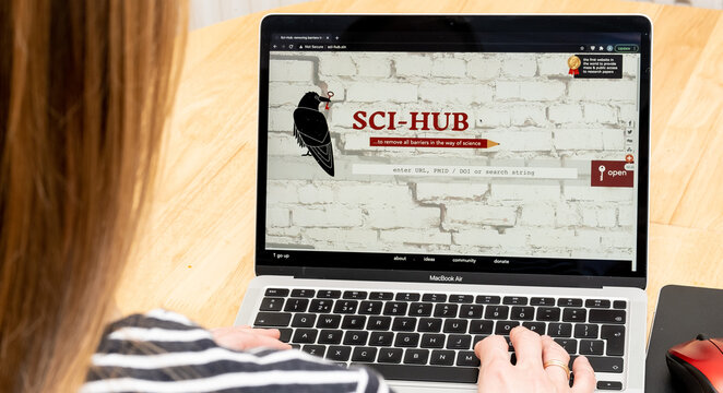 Sci-Hub library seen on the screen of laptop and a student in front of it. Sci Hub gives a free access to research papers books. Stafford, United Kingdom, March 21, 2021.