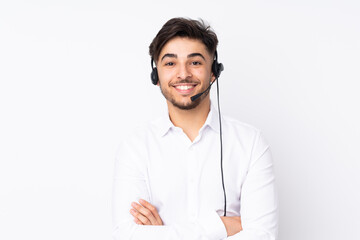 Telemarketer Arabian man working with a headset isolated on white background laughing