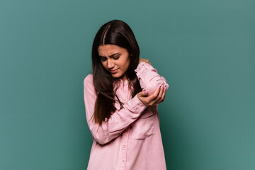 Young Indian woman isolated on blue background massaging elbow, suffering after a bad movement.