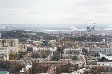 Urban view from rooftops of Kyiv city, Ukraine. Industrial landscape from above on moody day