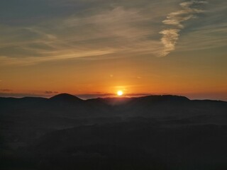 golden sunrise in the mountains with mountain sillouets - czech republic