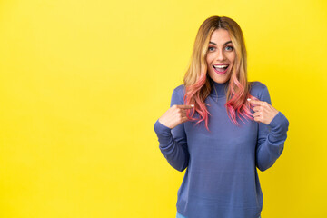 Young woman over isolated yellow background with surprise facial expression