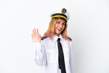 Airplane pilot over isolated white background saluting with hand with happy expression