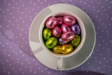 cup with chocolates purple background