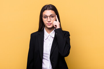 Young Indian business woman isolated on yellow background pointing temple with finger, thinking, focused on a task.