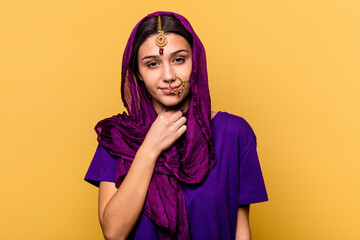 Young Indian woman wearing a traditional sari clothes isolated on yellow background suffers pain in throat due a virus or infection.