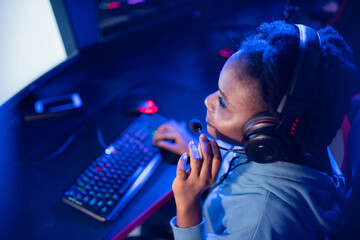 Professional Streamer African young woman cyber gamer in neon color blur background