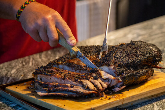 slicing a beef brisket fresh off of the smoker