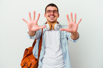Young caucasian student man listening to music isolated on white background showing number ten with...