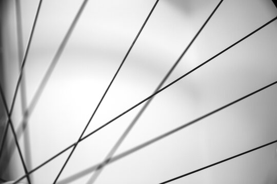 Close Up Of The Spokes From A Bike Wheel. Out Of Focus Abstract Of Parallel Line Of Bicycle