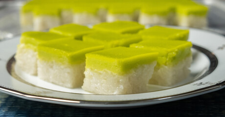 Malaysian dessert steamed glutinous rice with pandan layered custard or locally known as Kuih Seri Muka.