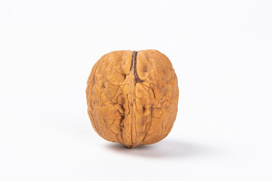 Closeup shot of a single walnut isolated on white background