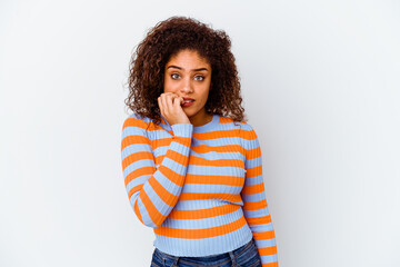 Young african american woman isolated on white background biting fingernails, nervous and very anxious.