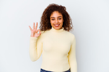 Young african american woman isolated on white background cheerful and confident showing ok gesture.