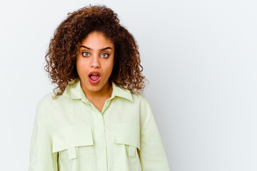 Young african american woman isolated on white background being shocked because of something she has seen.