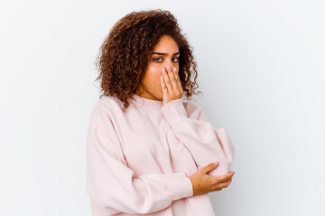 Young african american woman isolated on white background yawning showing a tired gesture covering mouth with hand.