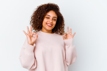 Young african american woman isolated on white background cheerful and confident showing ok gesture.