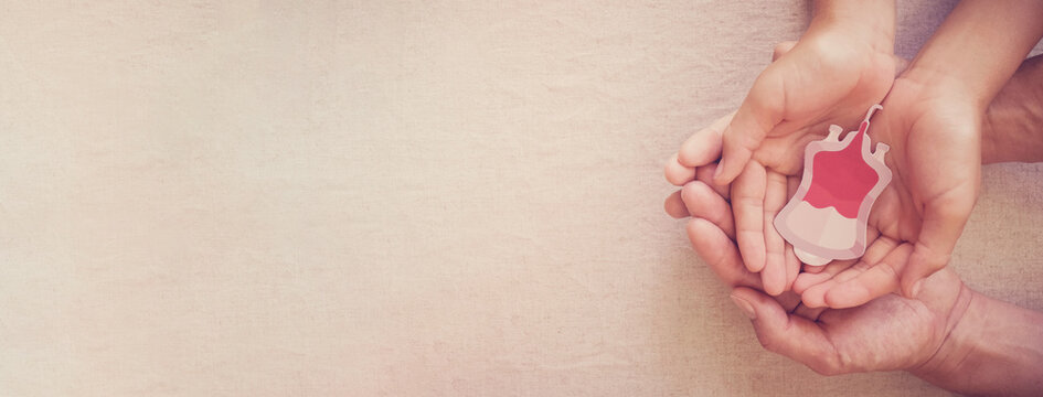 Hands holding blood bag, give blood donation, blood transfusion, world blood donor day, world hemophilia day concept