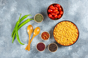 Wooden bowls of various spices on wooden board
