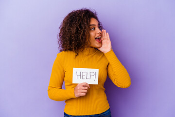 Young African American woman holding a Help placard isolated on purple background shouting and holding palm near opened mouth.