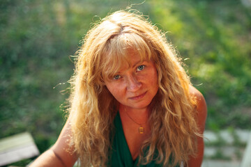 Portrait of woman with golden hair at summer.