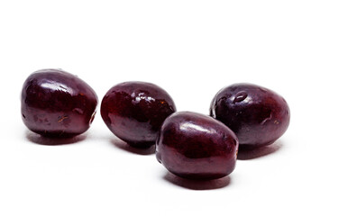 many red grapes on white background