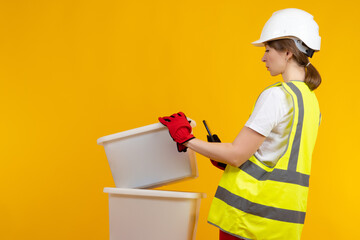 Application for order picking concept. Warehouse worker with a smartphone in his hands. She has an...