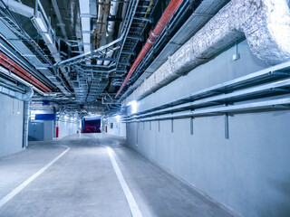 Engineering premises of  stadium. Auxiliary corridors for passage of special equipment. Place for passage of special equipment inside stadium. Spacious corridors of stadium with pipes under ceiling