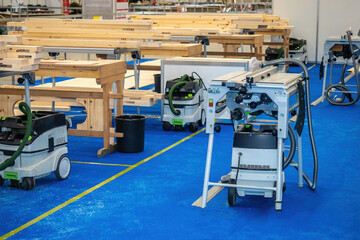 A spacious workshop for the production of furniture. Indoor woodworking equipment. A milling table for cutting wood. Concept - sale of milling equipment. Furniture workshop without people