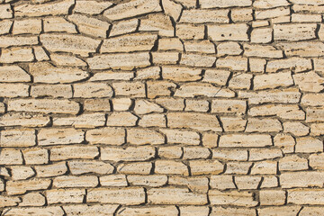Sand color stone or brick wall, modern texture background