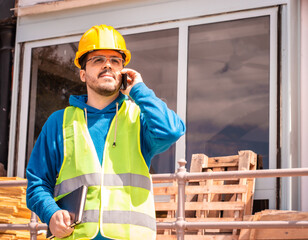 Latin male worker with hard hat and vest