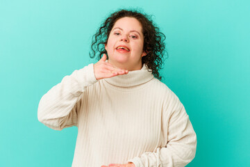 Woman with Down syndrome isolated holding something with both hands, product presentation.