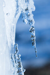 Fototapeta na wymiar icicles sparkling white with water drops ice hanging down