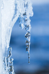 Fototapeta na wymiar icicles sparkling white with water drops ice hanging down