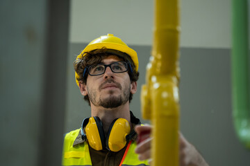 Electrician engineer checking technical data of heating system equipment and piping air compressor...