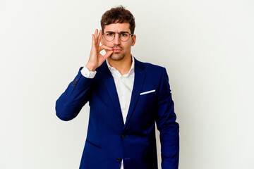 Young business caucasian man isolated on white background with fingers on lips keeping a secret.