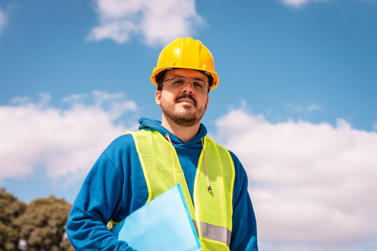 Latin male worker with hard hat and vest