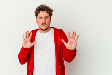 Young caucasian man isolated on white background rejecting someone showing a gesture of disgust.