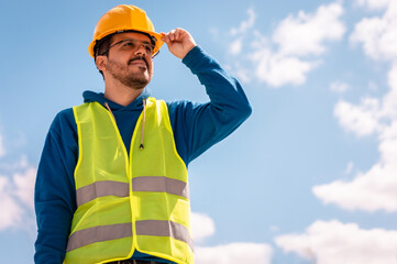 Latin male worker with hard hat and vest