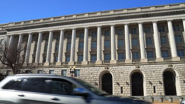 The Internal Revenue Service Building, headquarters of the IRS, in Washington, D.C. seen from Constitution Avenue NW during the day in early spring. The wide-angle camera view pans from left to right.