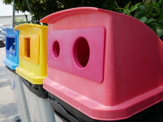 closeup of plastic recycling bins in gas station.